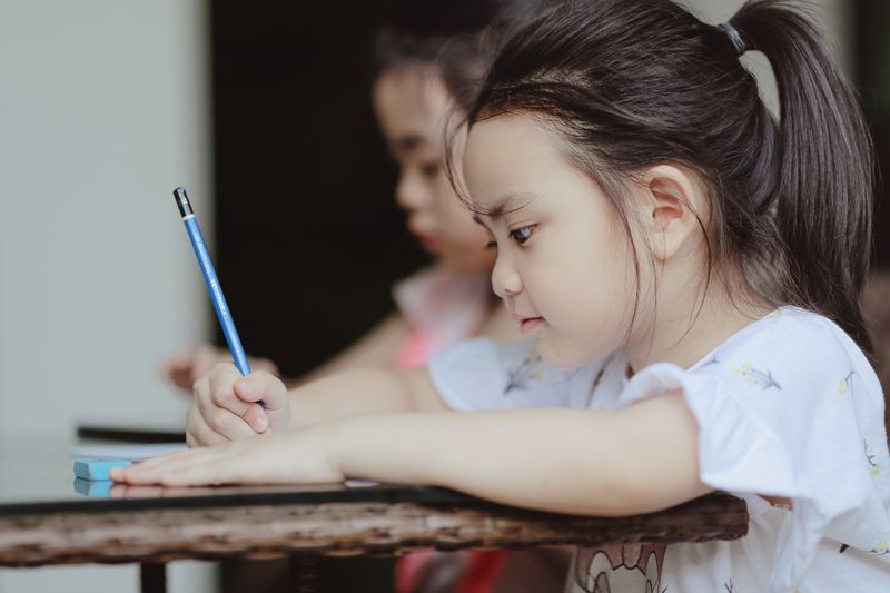 Asian children studying and learning in school